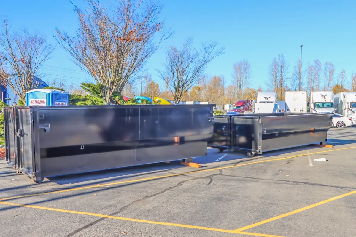 Professional dumpster rental service with roll-off container on residential driveway in Zephyrhills